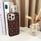 Monogram LV iPhone case shown from the back with gold-tone trim and protective fit