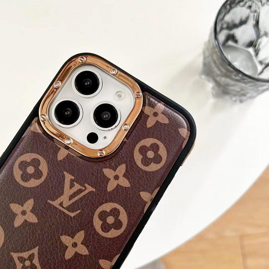 Detailed view of the luxury LV iPhone case showing monogram texture and metallic edges