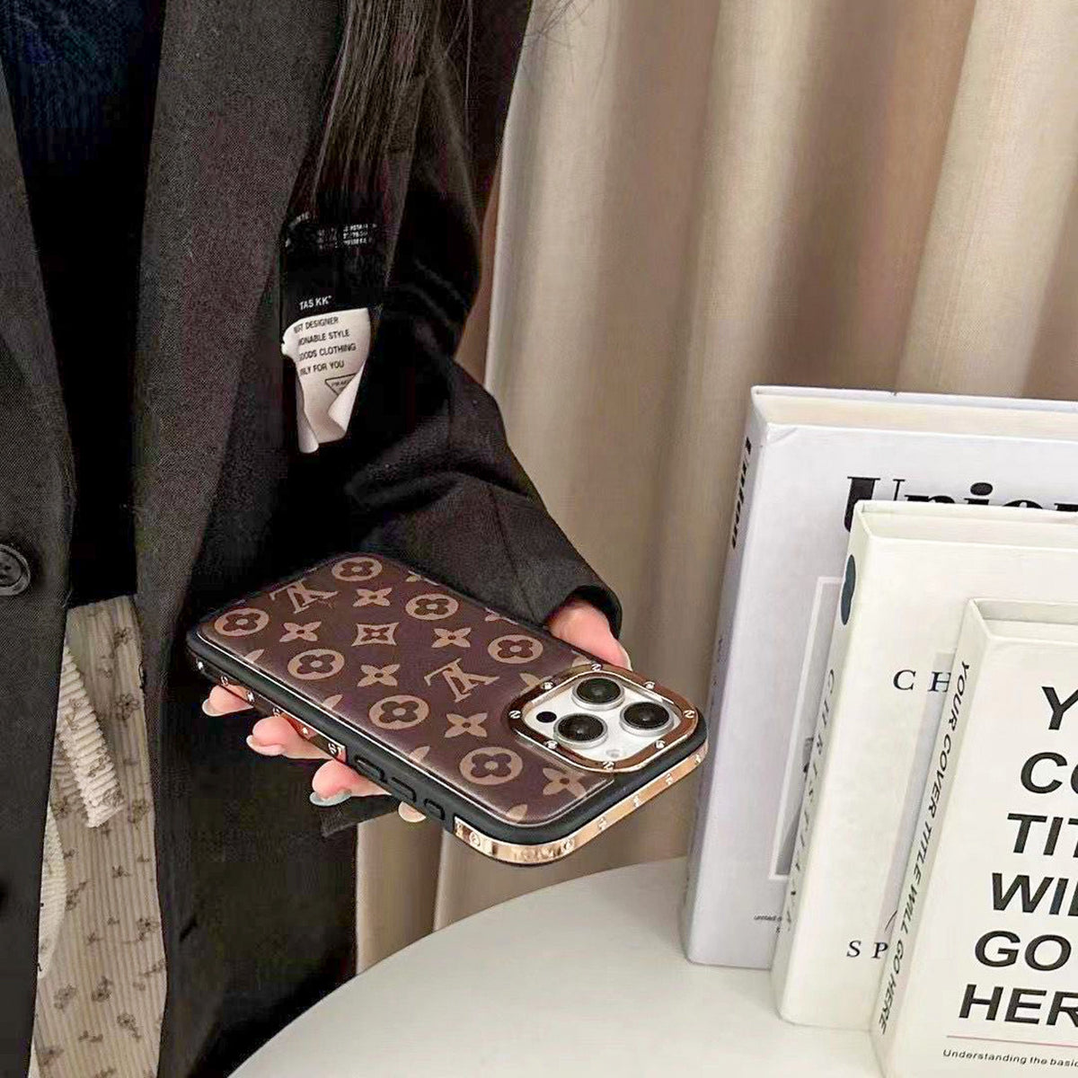Luxury monogram iPhone case showing the rear pattern, camera opening and golden frame