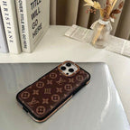 LV iPhone case with monogram design showing the polished gold-tone side protection