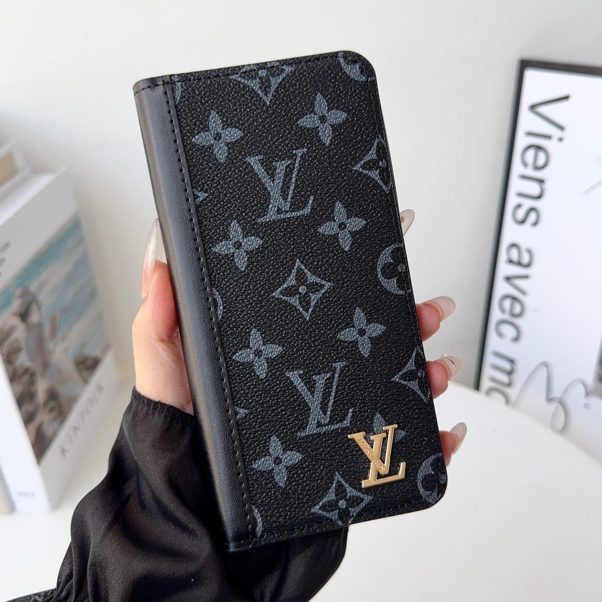 Louis V folio wallet iPhone case showing the folding wallet profile and fitted camera opening