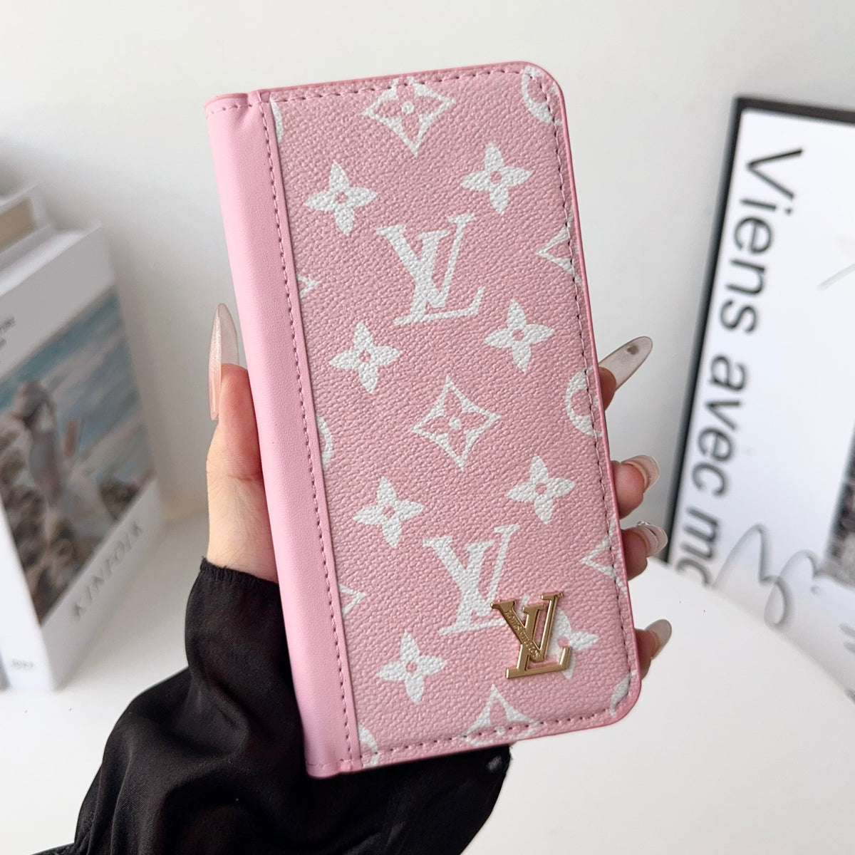 Louis V folio wallet iPhone case showing the fitted phone shell and slim folding profile