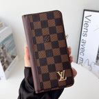 Louis V folio wallet iPhone case close-up showing the patterned leather and wallet detail