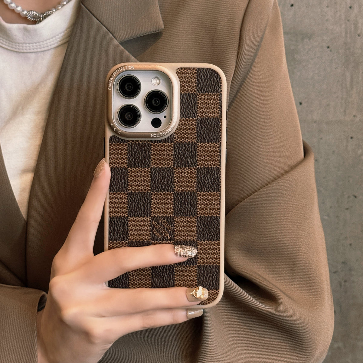 Brown checkered classic leather iPhone case showing the textured patterned back