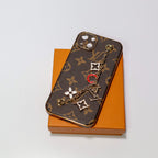 Luxury iPhone case with hand strap showing the patterned back and protective camera area