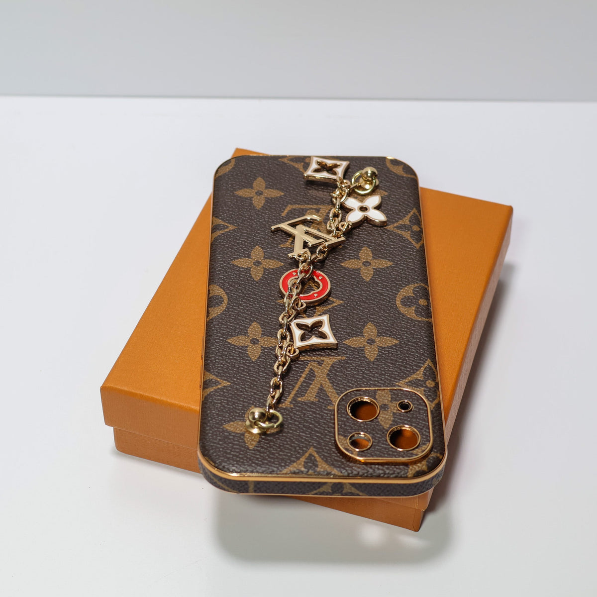 Close-up of the ornament hand strap phone case showing card storage and leather detail