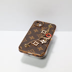 Detailed view of the luxury hand strap phone case highlighting decorative hardware