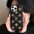 Luxury golden monogram leather iPhone case showing the gold-patterned back and camera opening