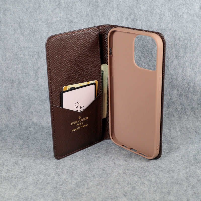 Brown checkered Louis Vuitton iPhone wallet case close-up showing leather texture and protective fit