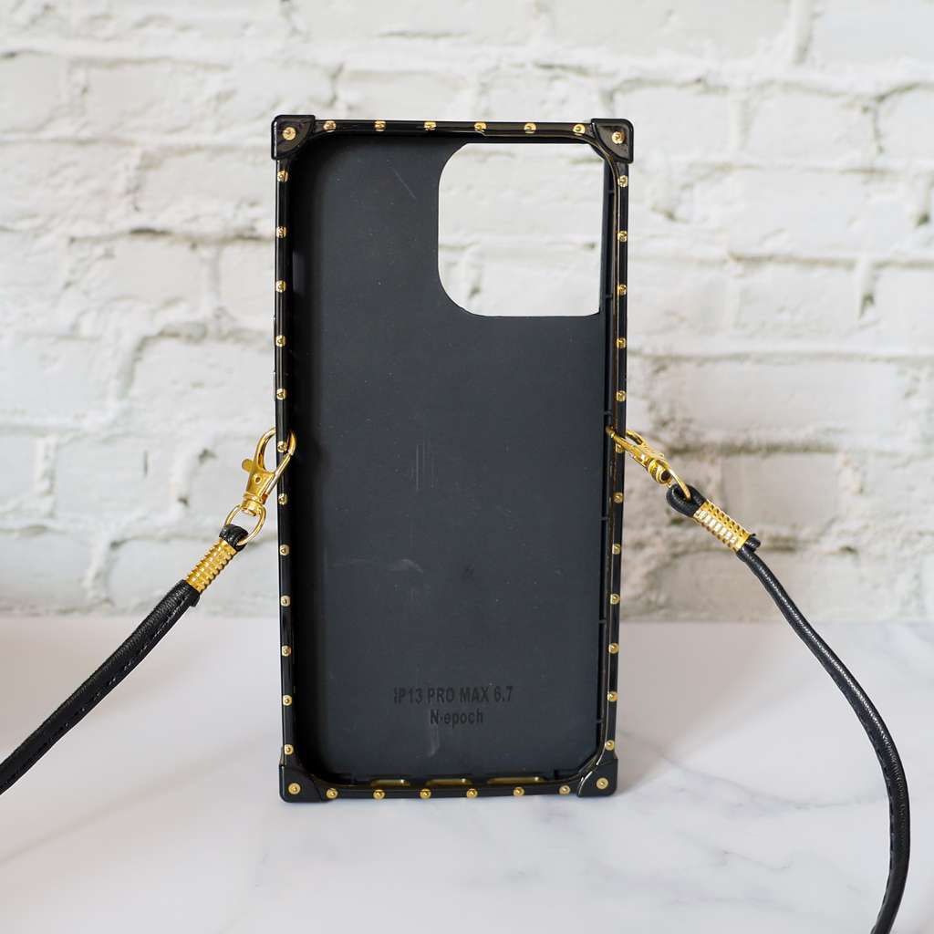 Designer trunk iPhone case showing the trunk-style back, camera opening and decorative hardware