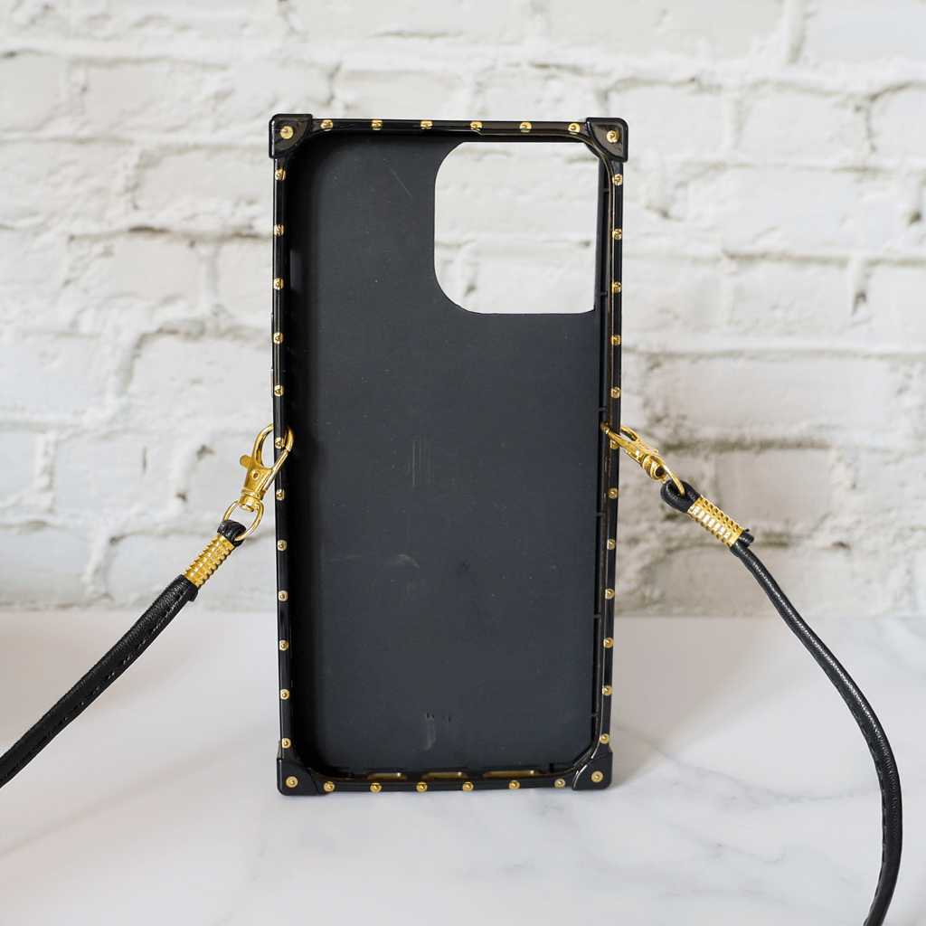 Designer trunk iPhone case showing the decorative trunk-style rear cover and camera area