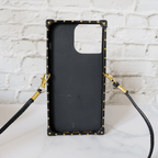 Designer trunk iPhone case showing the decorative trunk-style rear cover and camera area