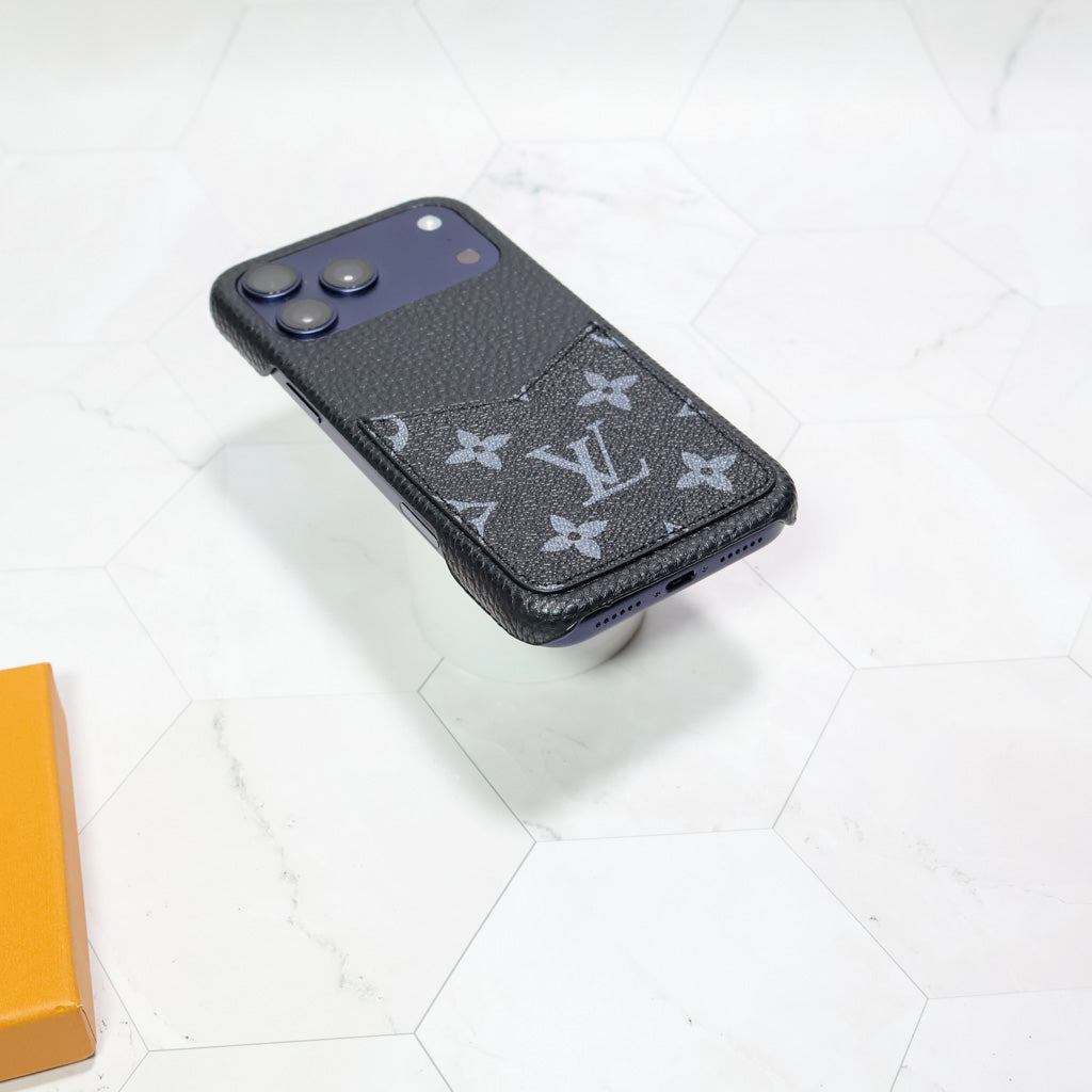 Close-up product view of the LV black monogram iPhone case and fitted camera area