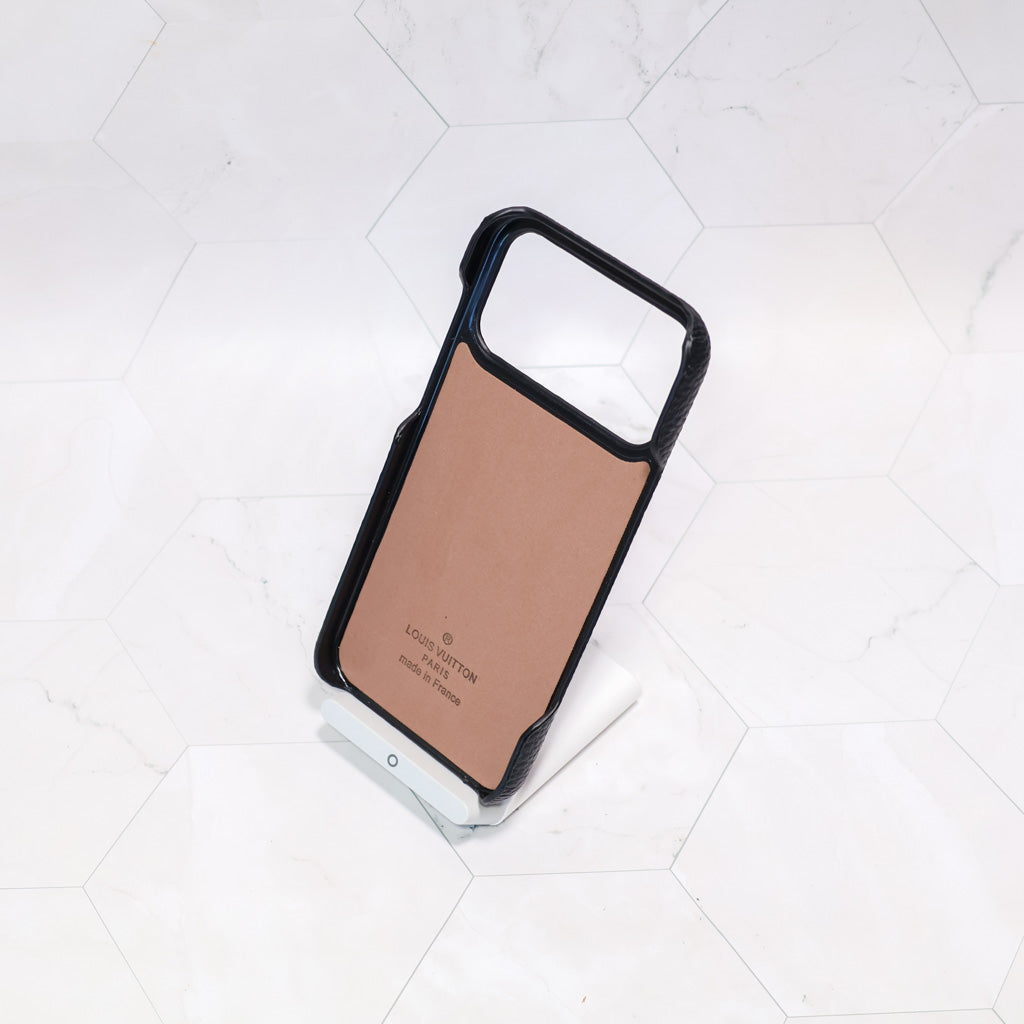 Close-up of the black monogram iPhone case highlighting leather texture and pattern