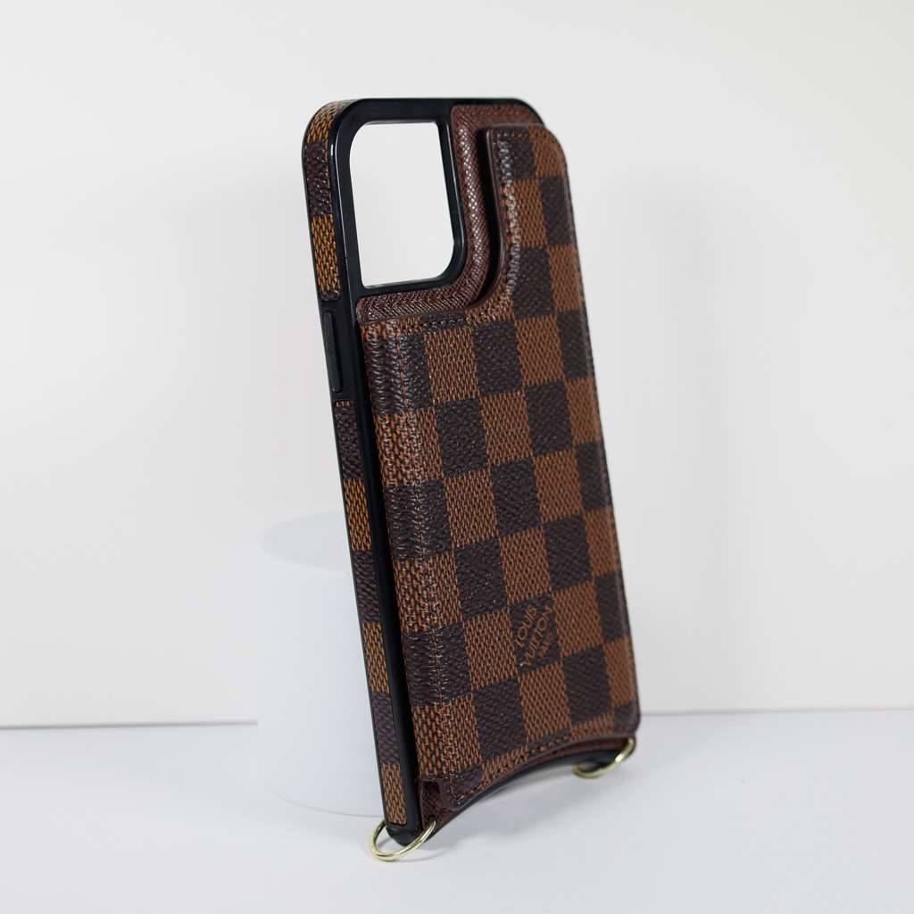 Checkered leather crossbody iPhone case showing the carrying strap and slim protective profile