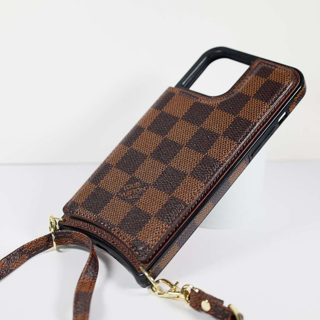 Checkered leather crossbody iPhone case shown with the shoulder strap for hands-free carrying