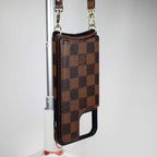Checkered leather crossbody iPhone case close-up showing the patterned surface and fitted edges