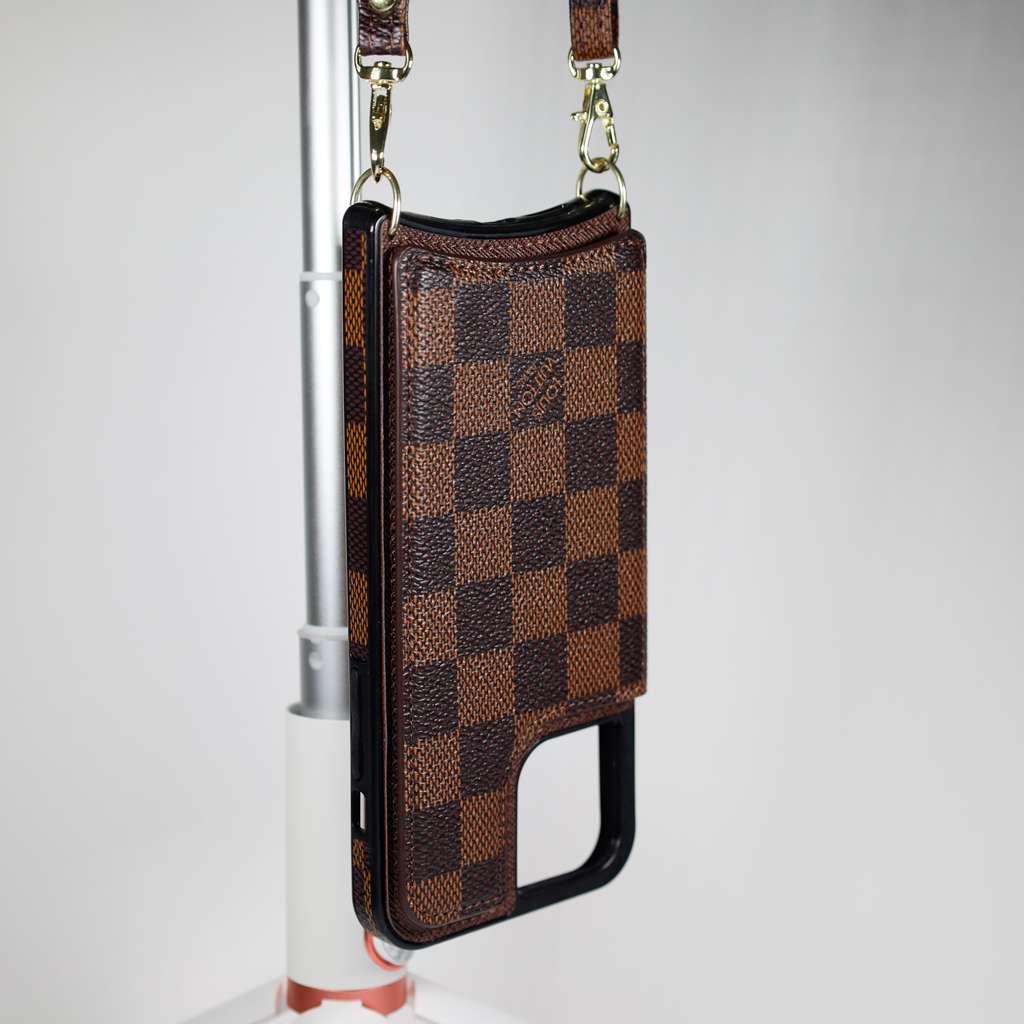 Checkered leather crossbody iPhone case close-up showing the patterned surface and fitted edges