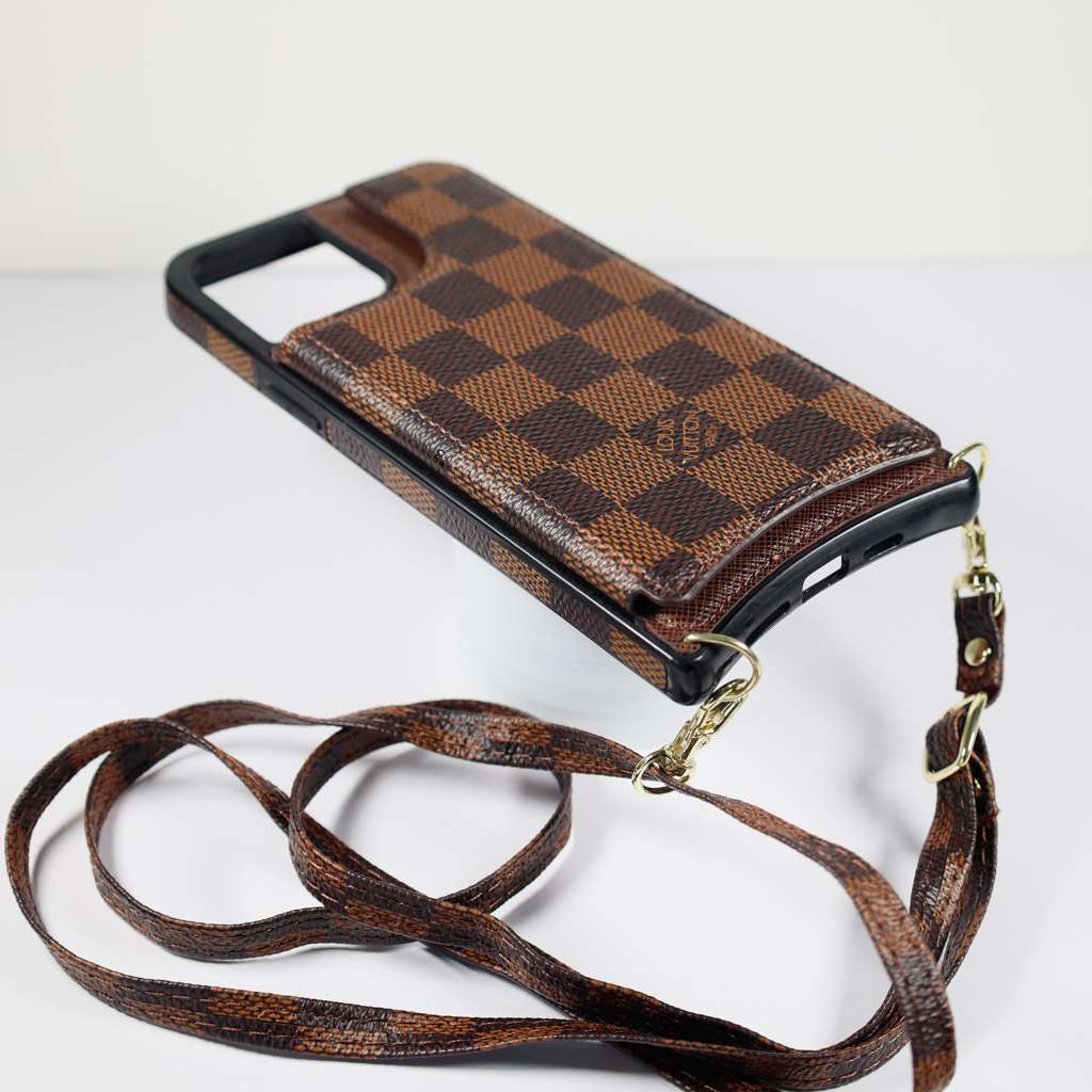 Checkered leather crossbody iPhone case showing the slim phone fit and carrying strap