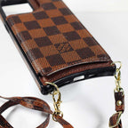 Checkered leather crossbody iPhone case showing the leather back, camera opening and protective corners