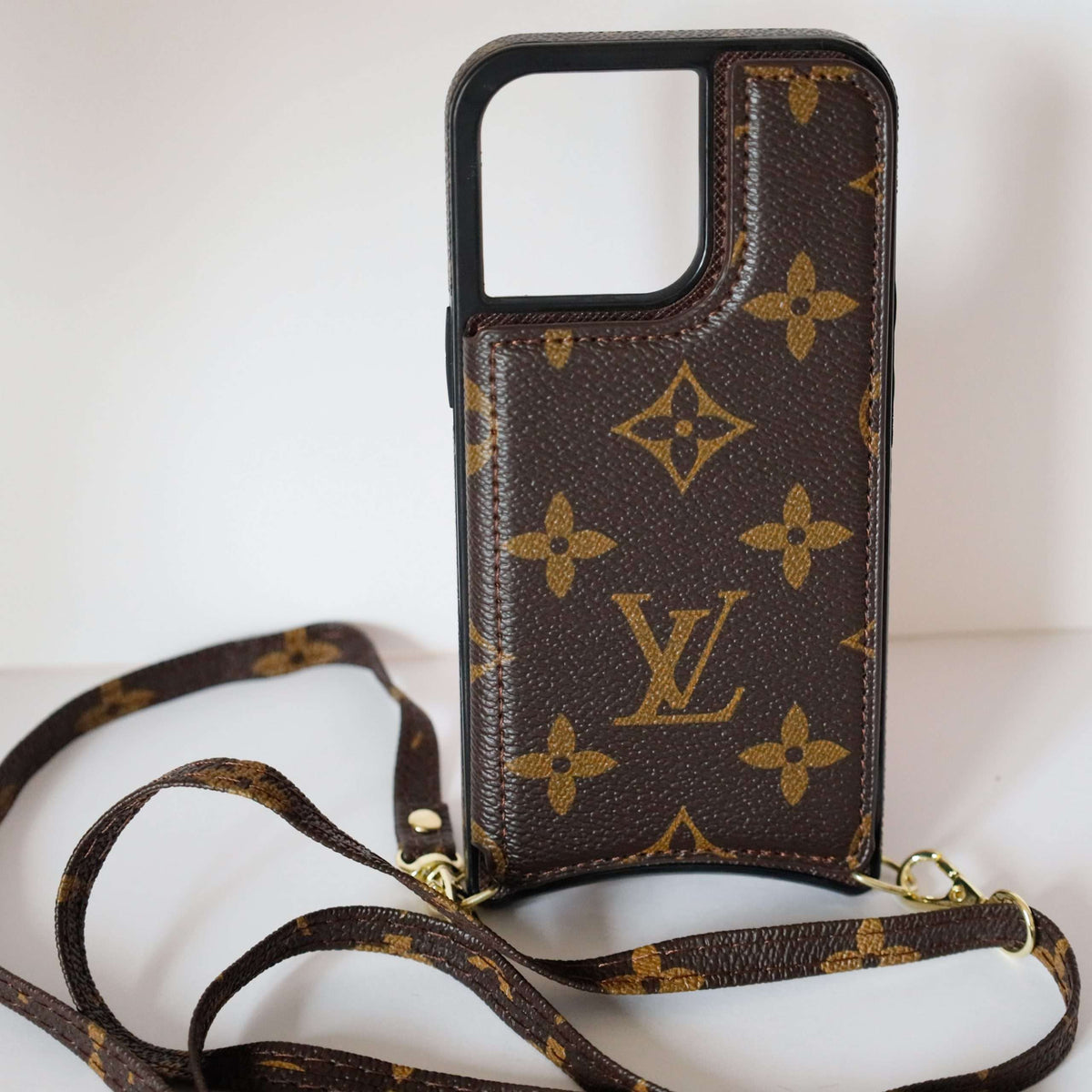 LV monogram leather iPhone case showing the slim profile and classic patterned back