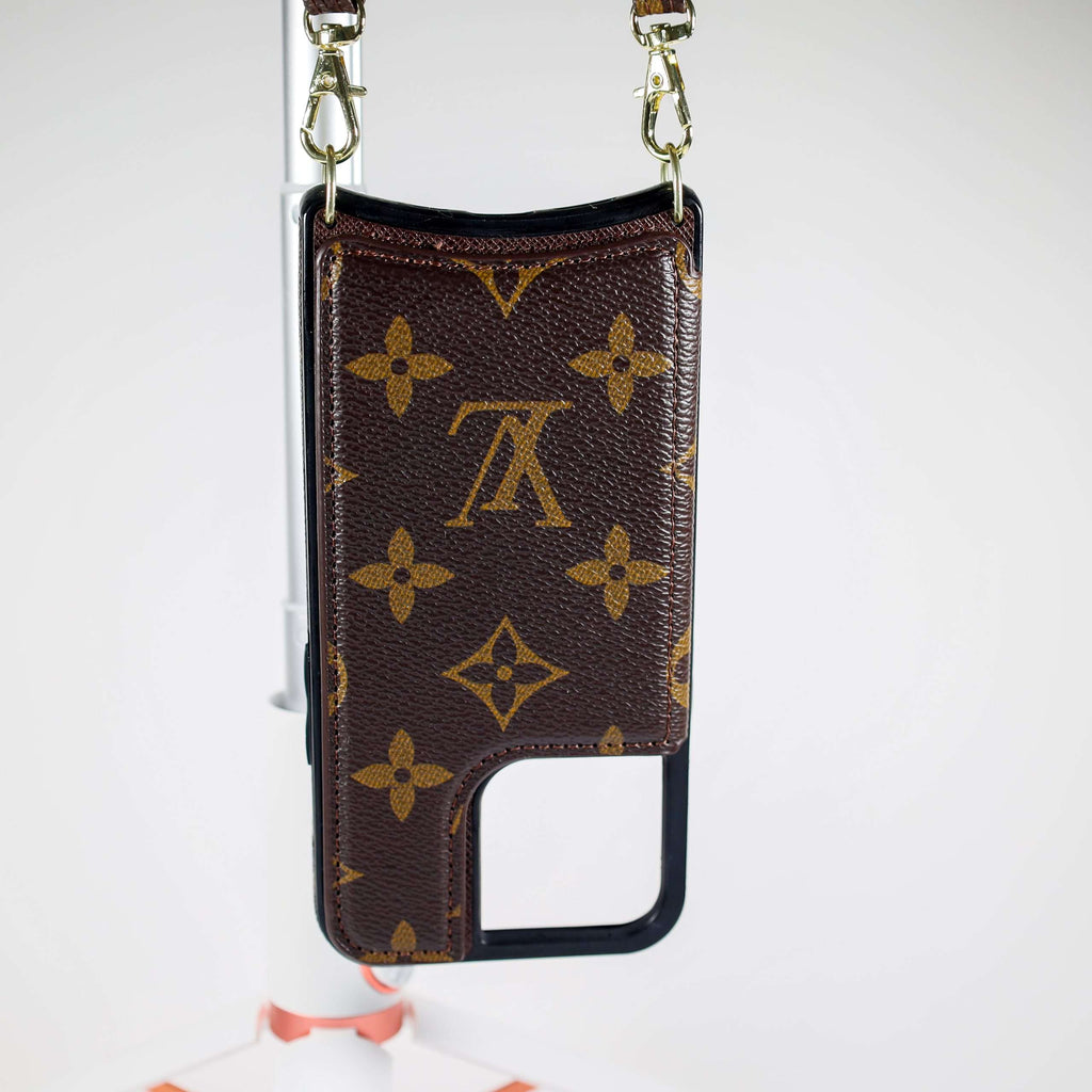 LV monogram leather iPhone case close-up showing the patterned surface and slim fit