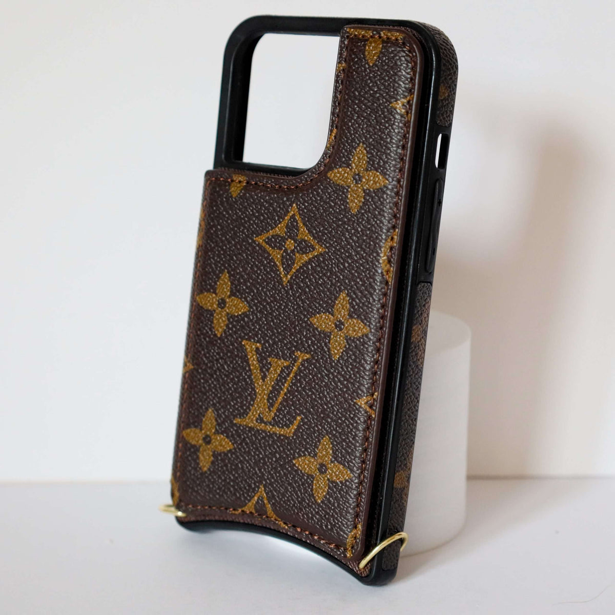 LV monogram leather iPhone case showing the patterned rear cover and protective camera opening
