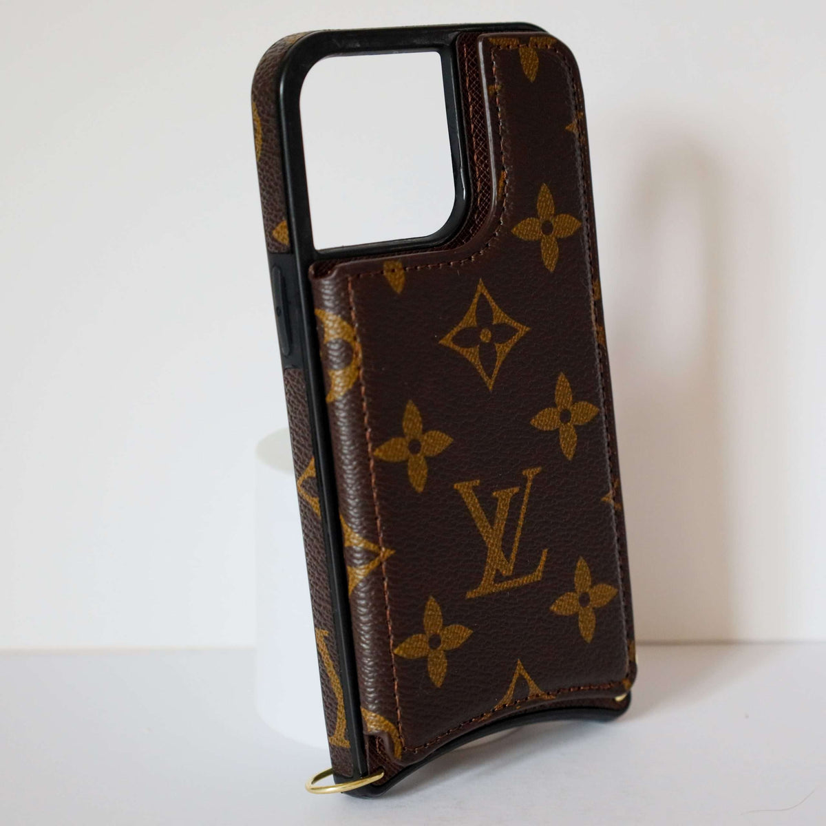 LV monogram leather iPhone case close-up showing leather texture and pattern detail