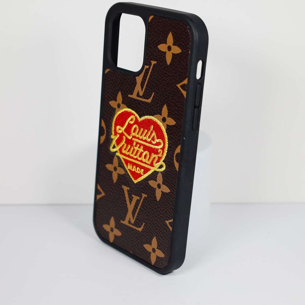 Close-up of the 3D heart iPhone case highlighting embroidery and leather texture