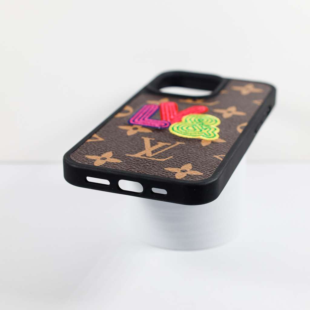 Embroidered iPhone case in leather showing the rear design, camera cutout and edges
