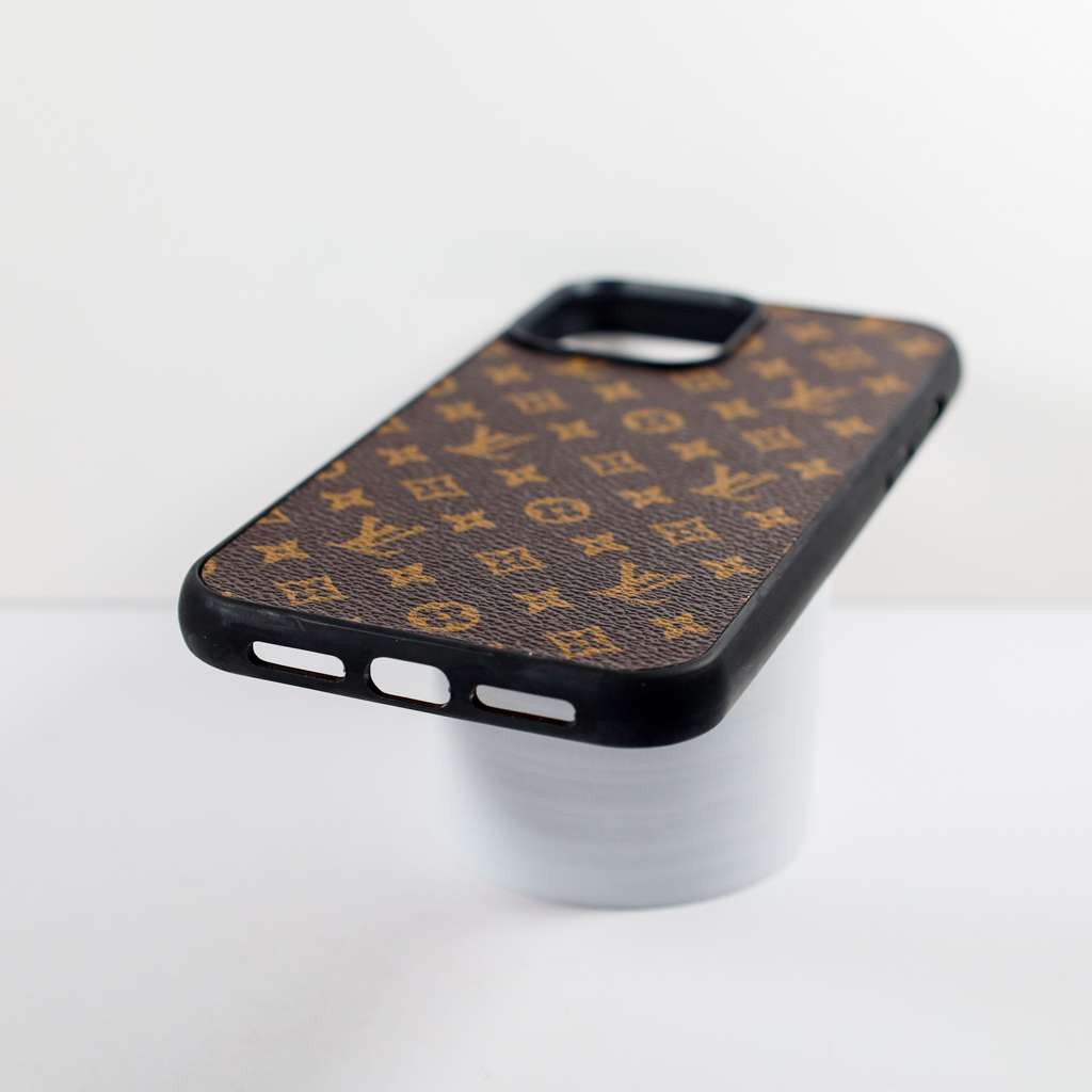 Detailed view of the brown monogram leather iPhone case and its patterned surface