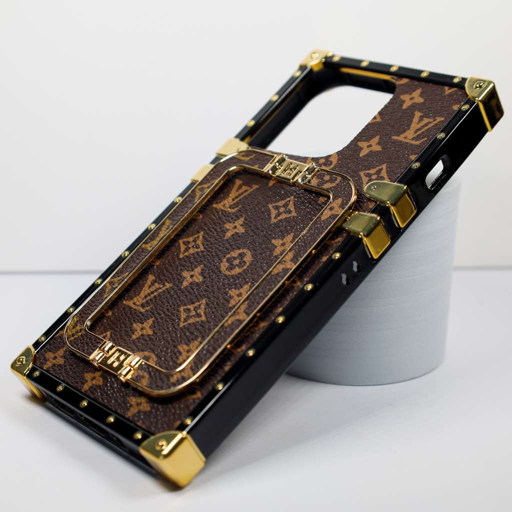 Luxury trunk iPhone case showing the kickstand opened for hands-free viewing
