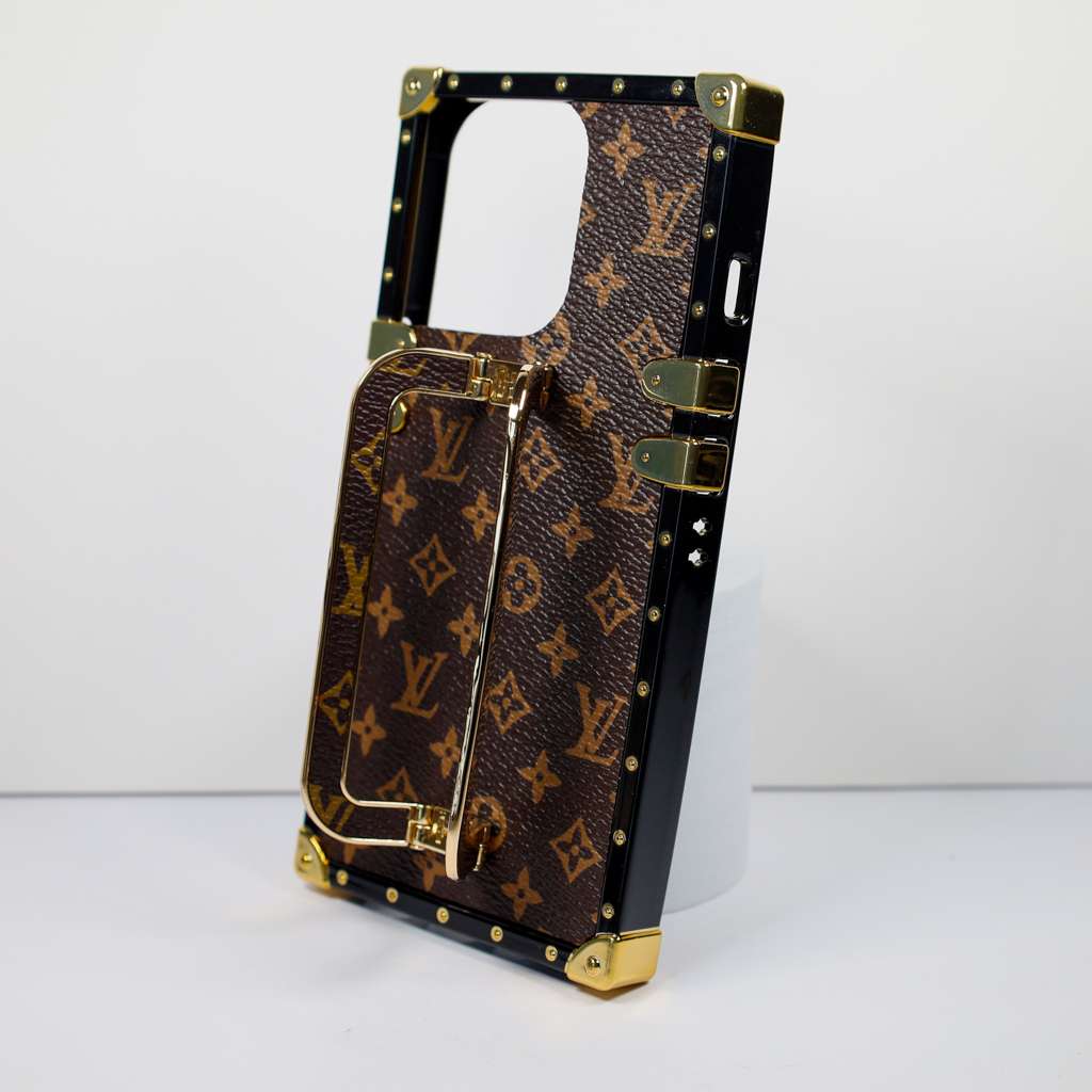 Luxury trunk iPhone case showing the patterned back, metal accents and protective corners