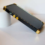 Louis Vuitton trunk iPhone case close-up showing the camera surround and hardware details