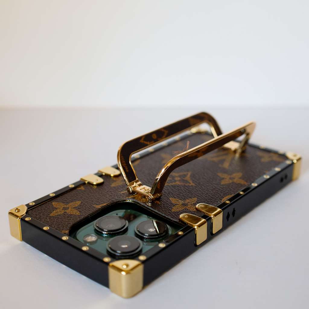 Louis Vuitton trunk iPhone case showing the leather-patterned back and fitted protective corners