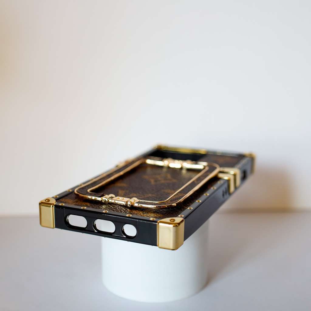 Louis Vuitton trunk iPhone case showing the protective frame, camera opening and rear design