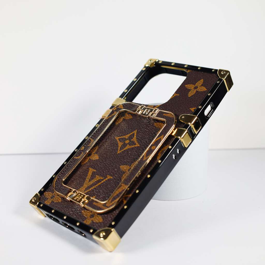Louis Vuitton trunk iPhone case showing the reinforced protective frame and camera area