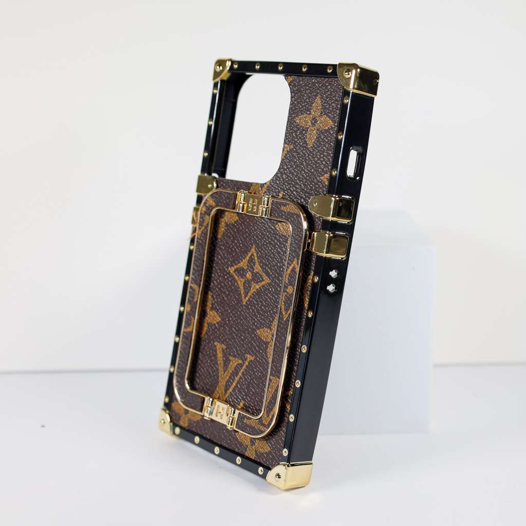 Louis Vuitton trunk iPhone case showing the structured rear cover and decorative hardware