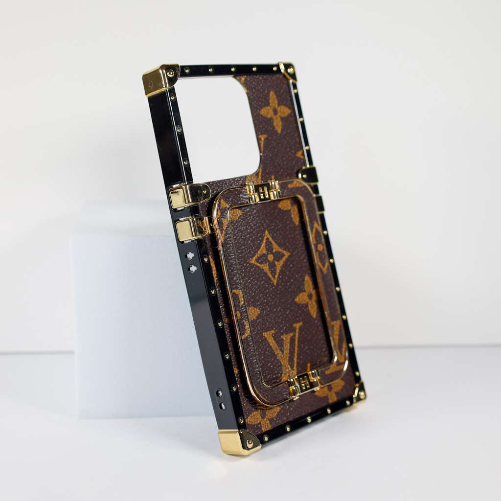 Louis Vuitton trunk iPhone case close-up showing the reinforced edge and patterned finish