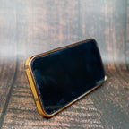Folding iPhone case with strap showing the rear design, camera area and leather texture