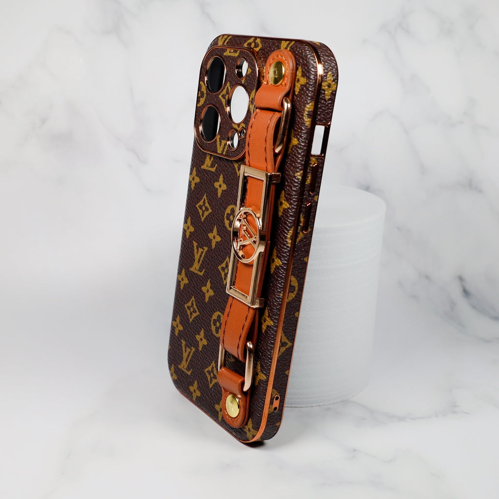 Brown LV folding iPhone case with strap showing the patterned cover and carrying detail