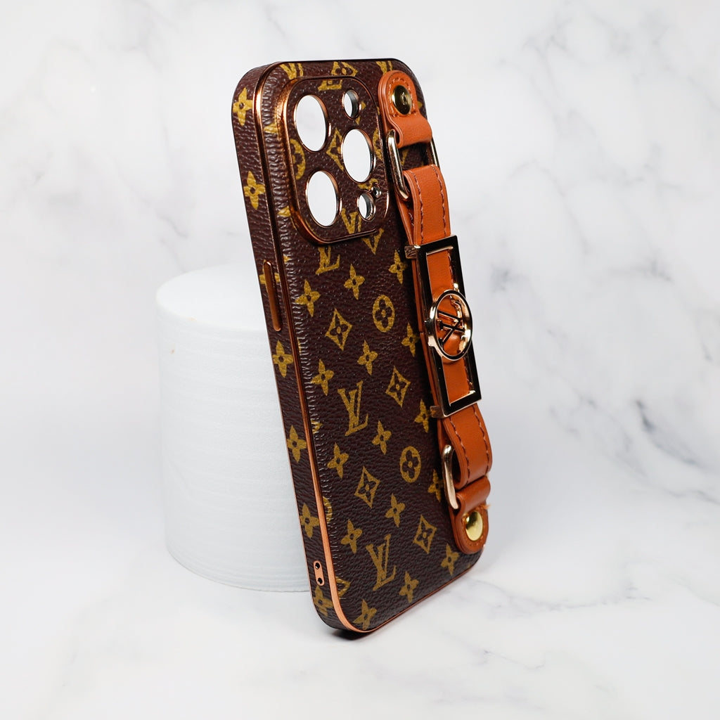 Close-up of the brown folding iPhone case showing the strap attachment and leather finish