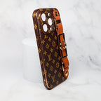 Close-up of the brown folding iPhone case showing the strap attachment and leather finish