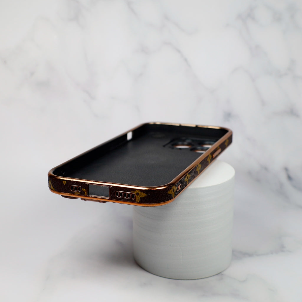 Detailed view of the LV brown strap iPhone case highlighting texture and fold construction