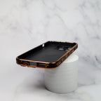 Detailed view of the LV brown strap iPhone case highlighting texture and fold construction