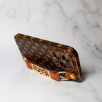 LV folding iPhone case with strap showing the full brown patterned exterior and fit