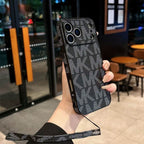 Hand strap MK iPhone case showing the fitted edge profile and decorative rear finish