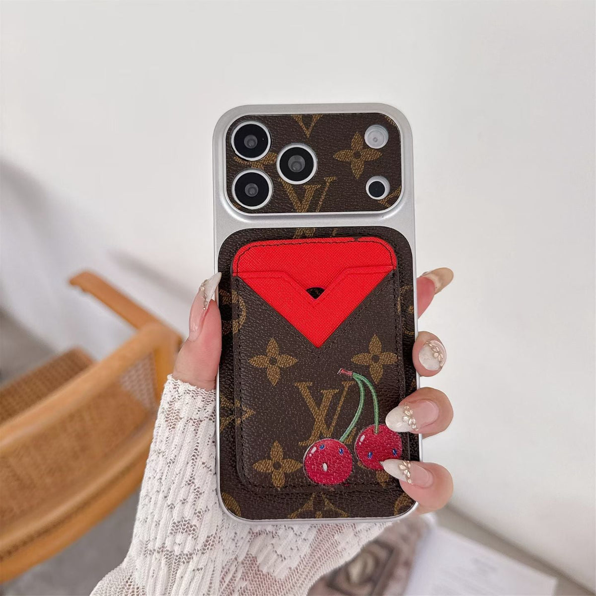 Magnetic card holder LV iPhone case showing the patterned leather back and detachable wallet