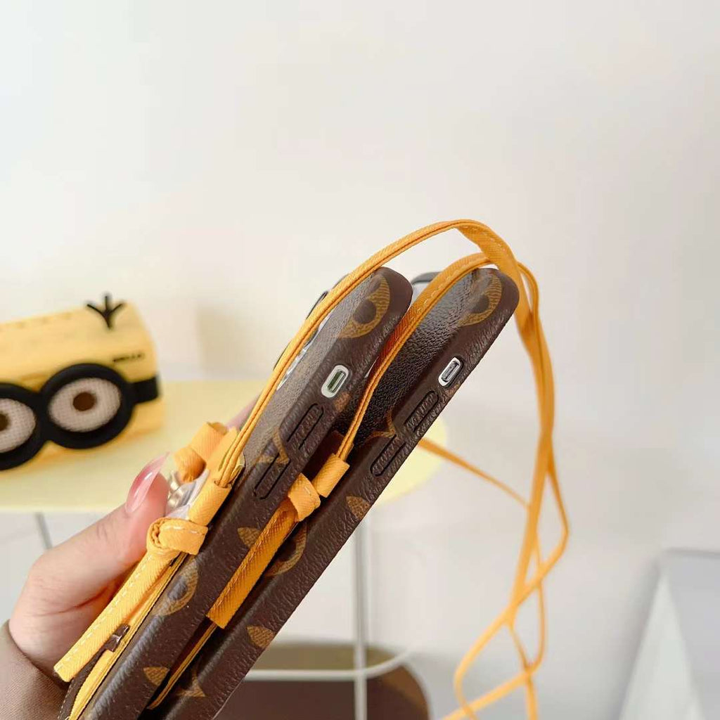 Brown Minions LV crossbody iPhone case showing the patterned rear cover and leather finish