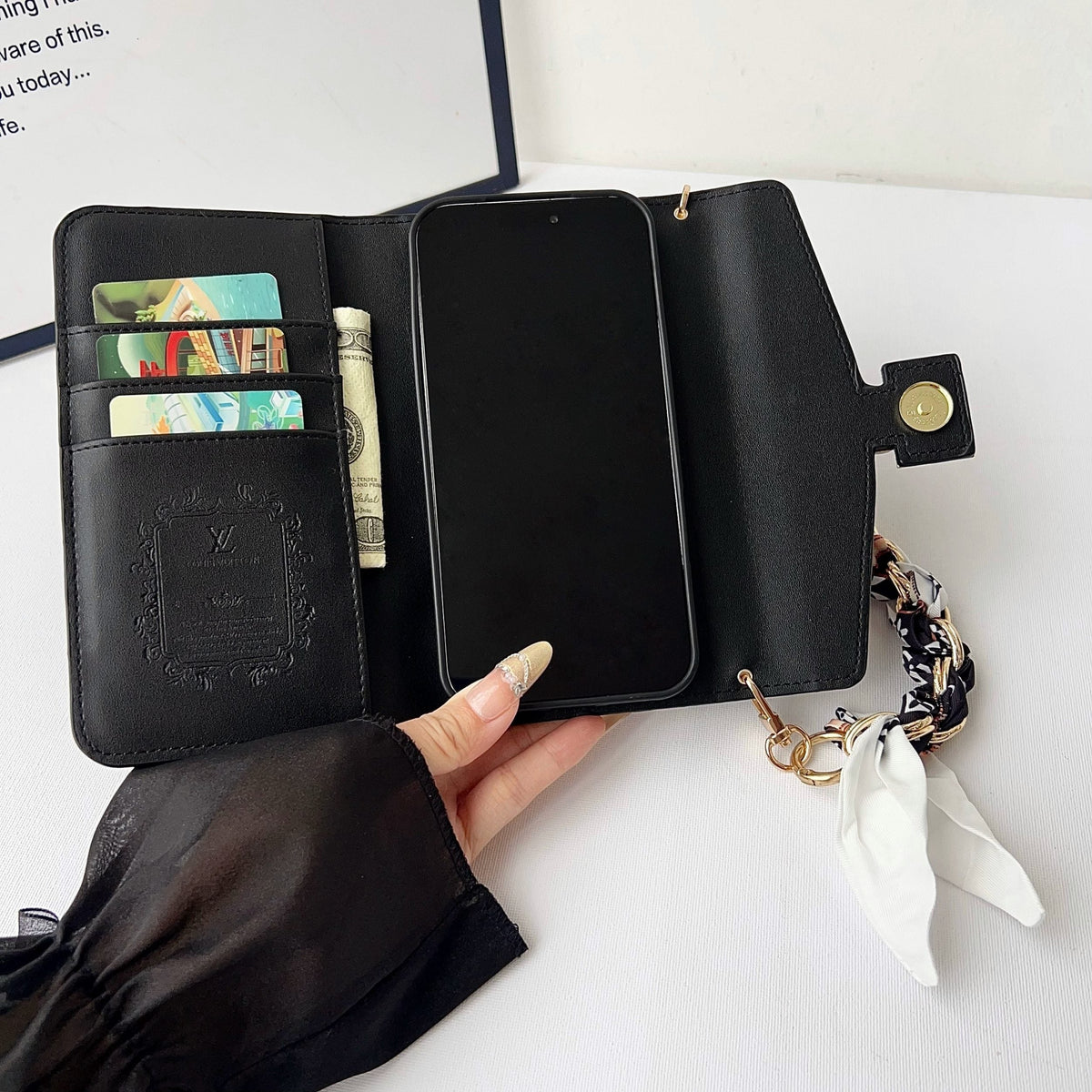 Close-up of the multicolor crossbody phone case showing the wallet detail and strap attachment